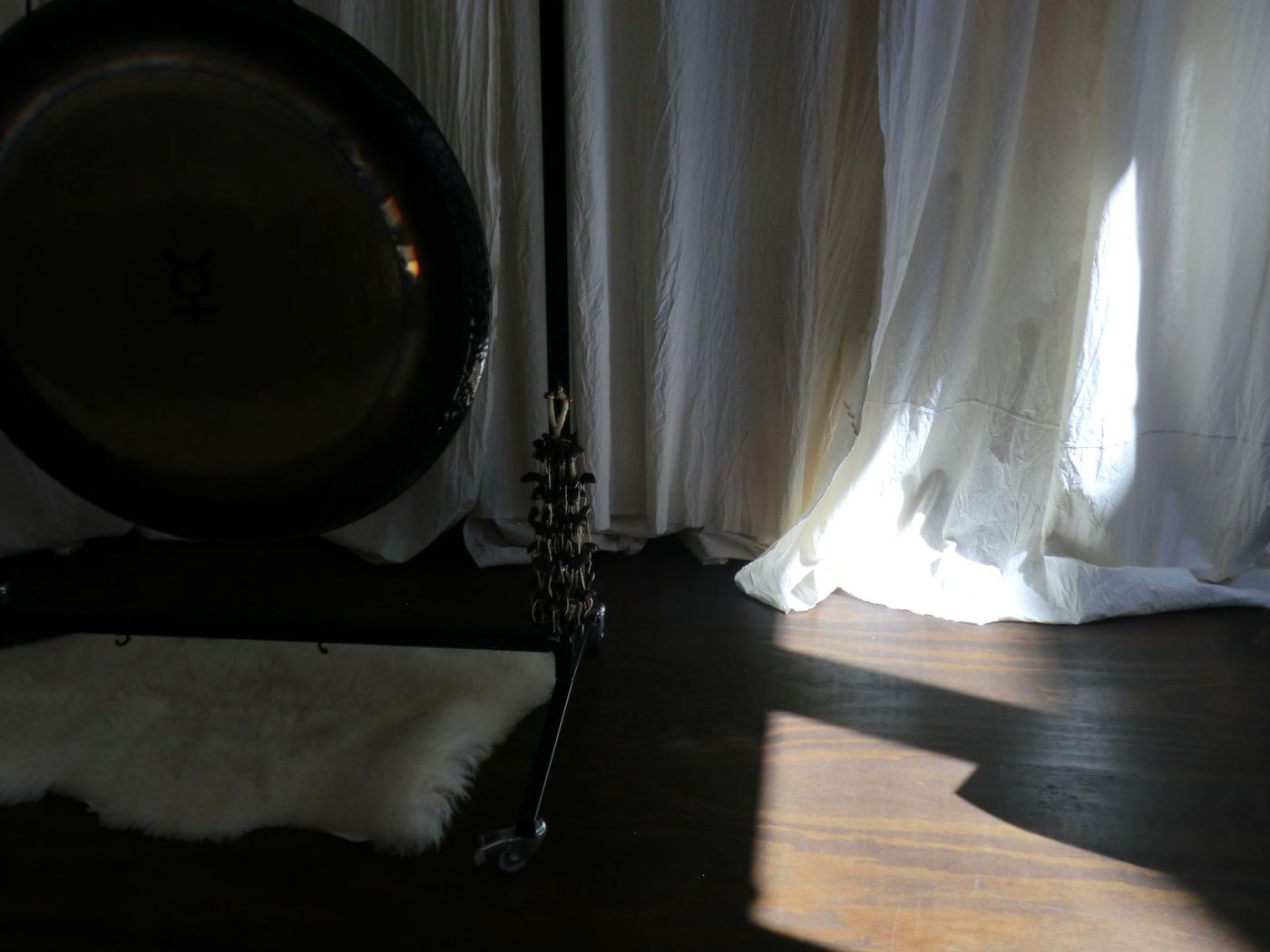 gong resting against soft daylight curtains